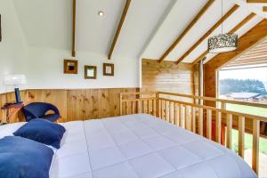 a bedroom with a large bed on a balcony at Loft y Cabañas Ensenada in Los Riscos