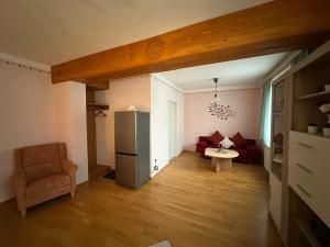 a living room with a refrigerator and a couch at Max and Moritz Top 9 in Liebenau