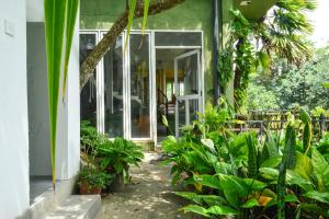 a house with a bunch of plants in front of it at Namaya Nature Resort & Cafe in Kandy