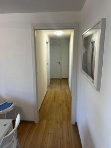 a hallway of an apartment with white walls and wooden floors at Casa Scrivani in Pineto