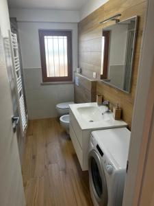 a bathroom with a sink and a washing machine at Casa Scrivani in Pineto +8 photos