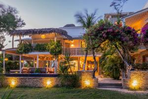 a house with flowers and lights in front of it at Villa Praia - La Villa Group in Jericoacoara