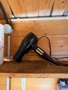 a black corded phone sitting on a shelf at la bulle d'Astrée in Le Tronchet