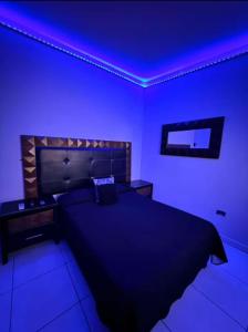 a bedroom with a bed with a blue lighting at Feng tower in Culiacán