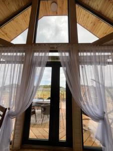 a large window with white curtains in a room at Barnhouse in Bosteri +7 photos
