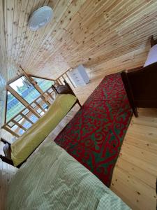 a bedroom with a bed and a rug in a room at Barnhouse in Bosteri