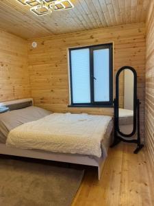 a bedroom with two beds and a window at Barnhouse in Bosteri