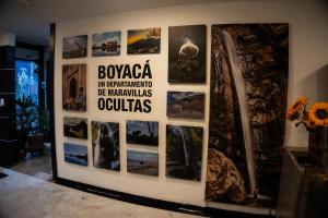 a wall of pictures on a wall in a room at Hotel Plaza Muisca in Tunja