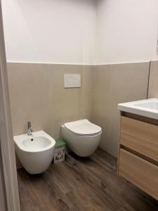 a bathroom with a toilet and a bidet and a sink at Casa DeA in Giardini Naxos +4 photos