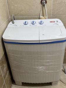 a washer and dryer sitting in a bathroom at Spacious Villa-walking to beach in Marsa Matruh