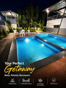 a swimming pool in front of a house at night at Ganga Bliss Riverside in Haridwār