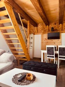 a living room with a spiral staircase in a cabin at Cottage Bellis in Pošćenje