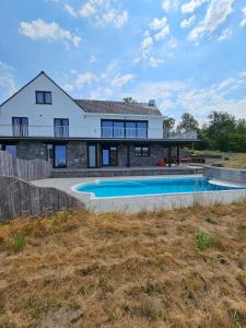 a house with a swimming pool in front of it at Les Terrasses de Laloux in Rochefort