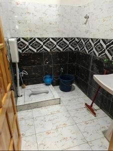 a bathroom with a toilet and a sink at The Abbott Crown Hotel Rajwal in Kāgān