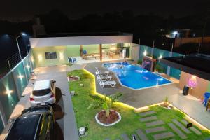 a car parked in front of a house with a pool at Quinta Heluue in Ciudad del Este
