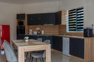 a kitchen with a table and chairs in a room at Crystalapartmanhaz in Gyula +20 photos