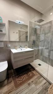 a bathroom with a sink and a shower and a toilet at argentario home in Porto Santo Stefano +22 photos