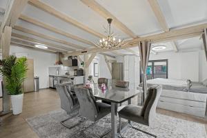 a dining room with a table and chairs and a bed at Golden Grey Loft Bahrenfeld Volkspark Hamburg in Hamburg +22 photos
