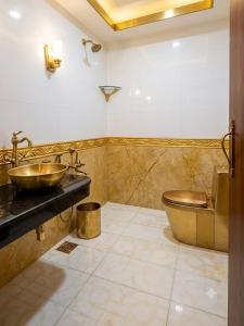 a bathroom with a sink and a toilet at Hotel Coral Shade's in Mahabalipuram +16 photos