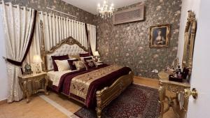 a bedroom with a canopy bed and floral wallpaper at Hotel Coral Shade's in Mahabalipuram