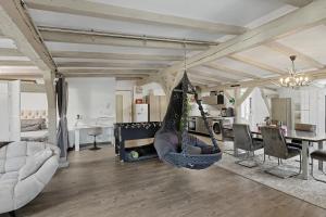 a room with a hammock hanging from the ceiling at Golden Grey Loft Bahrenfeld Volkspark Hamburg in Hamburg