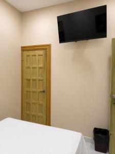 a room with a flat screen tv on the wall at Hotel Castillo in San Pedro Sula