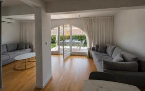 a living room with a couch and a table at Vila Ester - apartman Lovrana in Lovran