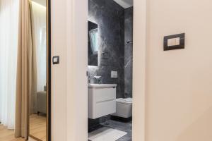 a bathroom with a sink and a toilet at Ambra & Arber Hotel in Bogovë +56 photos