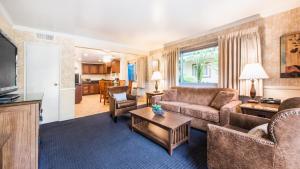 a living room with a couch and a table at Inn by the Harbor in Santa Barbara