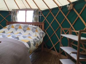 a room with a bed in a yurt at Yurt Ash tree in Saint Briavels