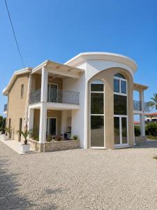 a large white house with a large window at Villa Elysia Tropea in Tropea