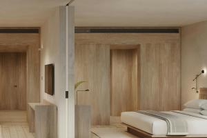 a bedroom with a bed and wooden walls at The Cape Town EDITION in Cape Town