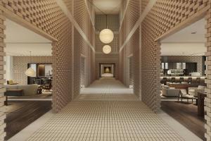 a corridor of a hotel lobby with a tile wall at The Cape Town EDITION in Cape Town
