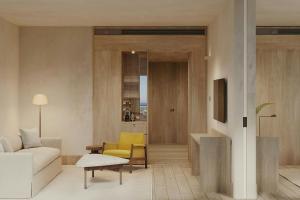 a living room with a couch and a yellow chair at The Cape Town EDITION in Cape Town