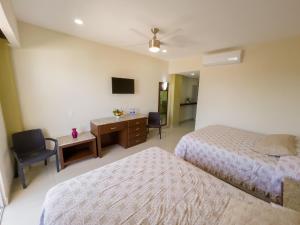 a hotel room with two beds and a desk at Hotel Bogavante in Barra de Navidad +66 photos
