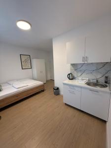 a kitchen with a bed and a sink in a room at Capital Stay Old Town in Sarajevo +35 photos