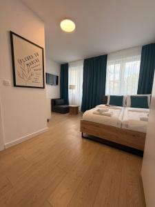 a bedroom with a bed and a living room at Capital Stay Old Town in Sarajevo