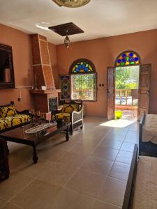 a living room with two couches and stained glass windows at Casa Sofia in Meknès