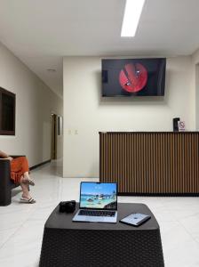 a laptop computer sitting on a table in a room at Hotel Castillo in San Pedro Sula
