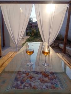 two glasses of wine on a table next to a pool at Villa Harmony in Xanthi