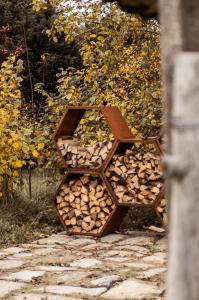 a pile of fire wood sitting on a sidewalk at Domein de Koekoeksvlooghe in Lo-Reninge +6 photos