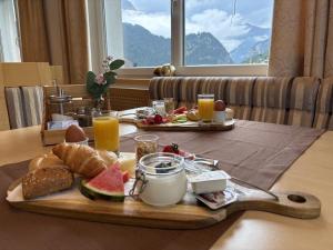 a tray of breakfast food on a table with orange juice at Amontanara in Nauders
