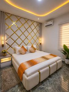 a bedroom with a king sized bed in a room at Oak Haven Lodging & Suites in Sagamu