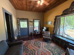 a living room with a couch and a chair and a window at Priest Station Cafe & Cabins in Groveland +20 photos