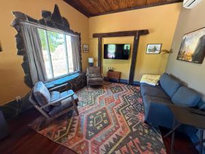 a living room with a couch and a rug at Priest Station Cafe & Cabins in Groveland