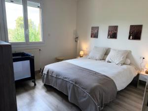 a bedroom with a large bed and a television at Gîte Chez Clara in Rocamadour