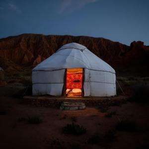 a dome tent with an open door in the desert at Mars Canyon Yurt Camp in Tong