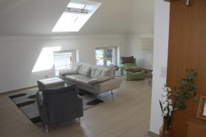 a living room with a couch and a chair at Allegra am Niederrhein in Neukirchen-Vluyn