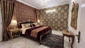 a bedroom with a bed and a chandelier at Hotel Sakthi-Pallava Shore's in Mahabalipuram +17 photos
