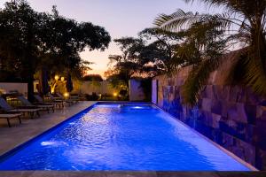 a swimming pool with blue lighting in a backyard at Hotel Alma Boutique in Jiutepec